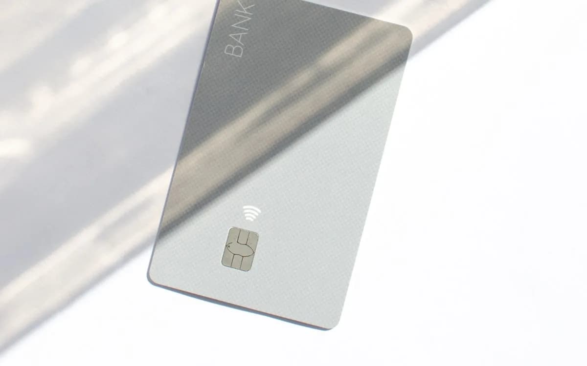 A contactless bank card resting in soft daylight